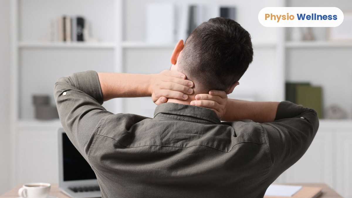 Office worker at a desk in Etobicoke holding his neck because of pain from sitting all day