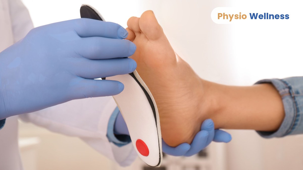 Clinician fitting a custom orthotic to a patient's foot at a physiotherapy clinic in Etobicoke