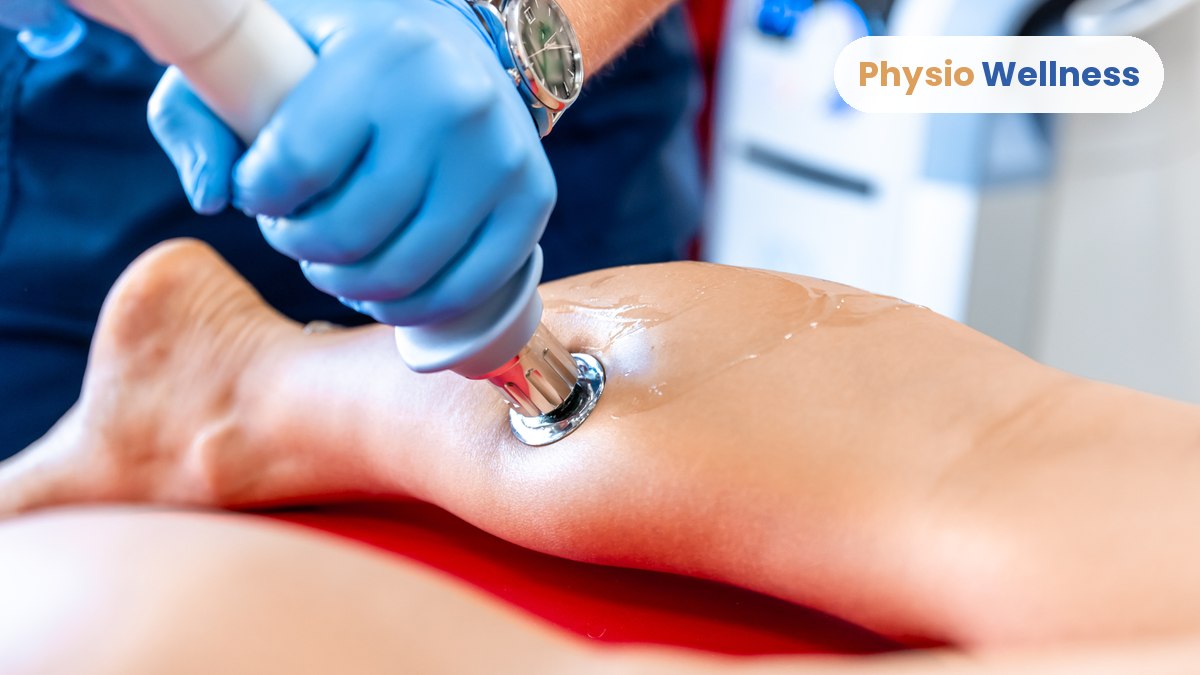 Shockwave therapy handpiece being applied to a client’s lower leg at Physiotherapy Wellness Inst in Etobicoke