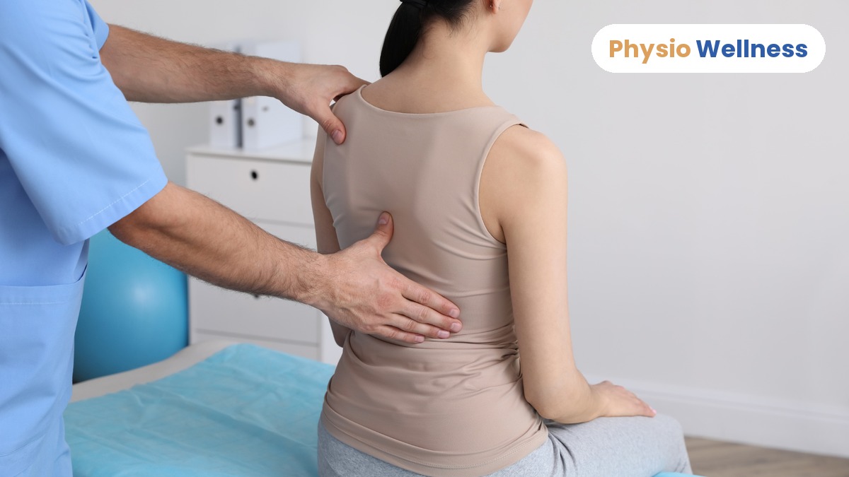 Physiotherapist assessing a patient’s back before spinal decompression treatment in Etobicoke