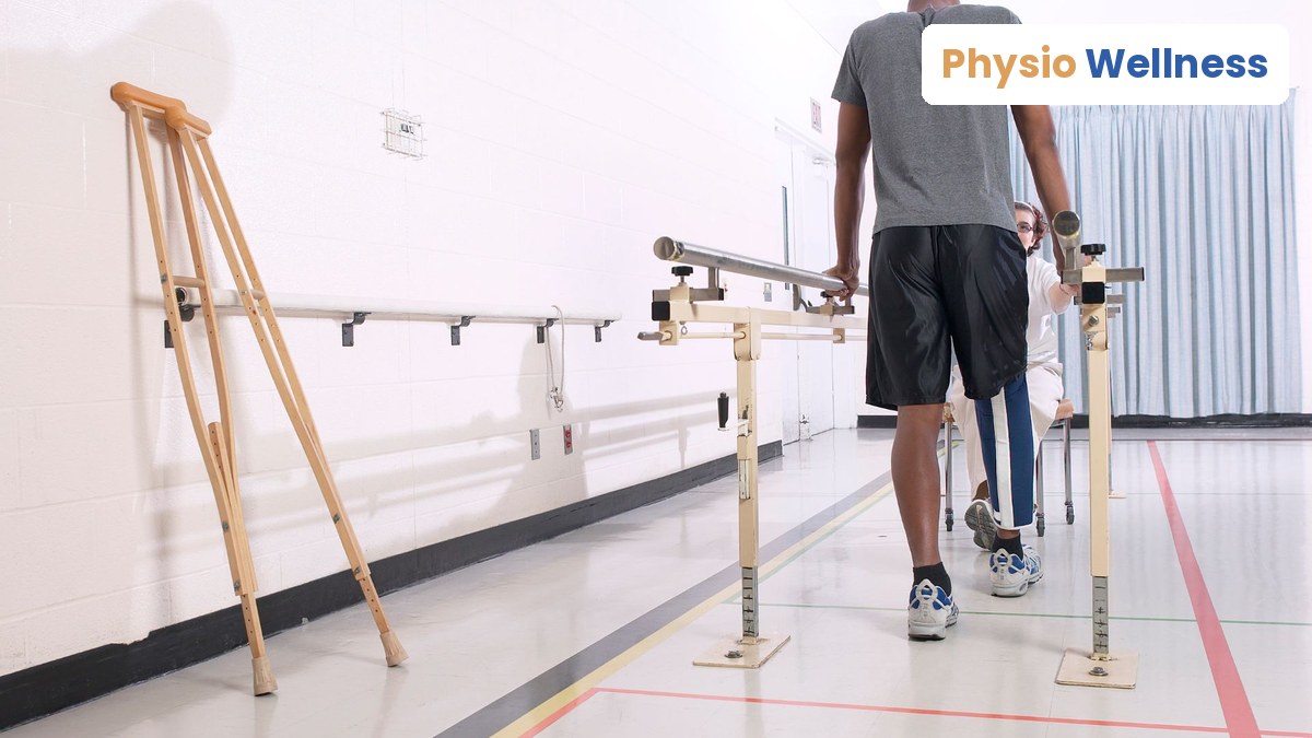 Injured worker rebuilding mobility on parallel bars with a physiotherapist during return-to-work rehabilitation