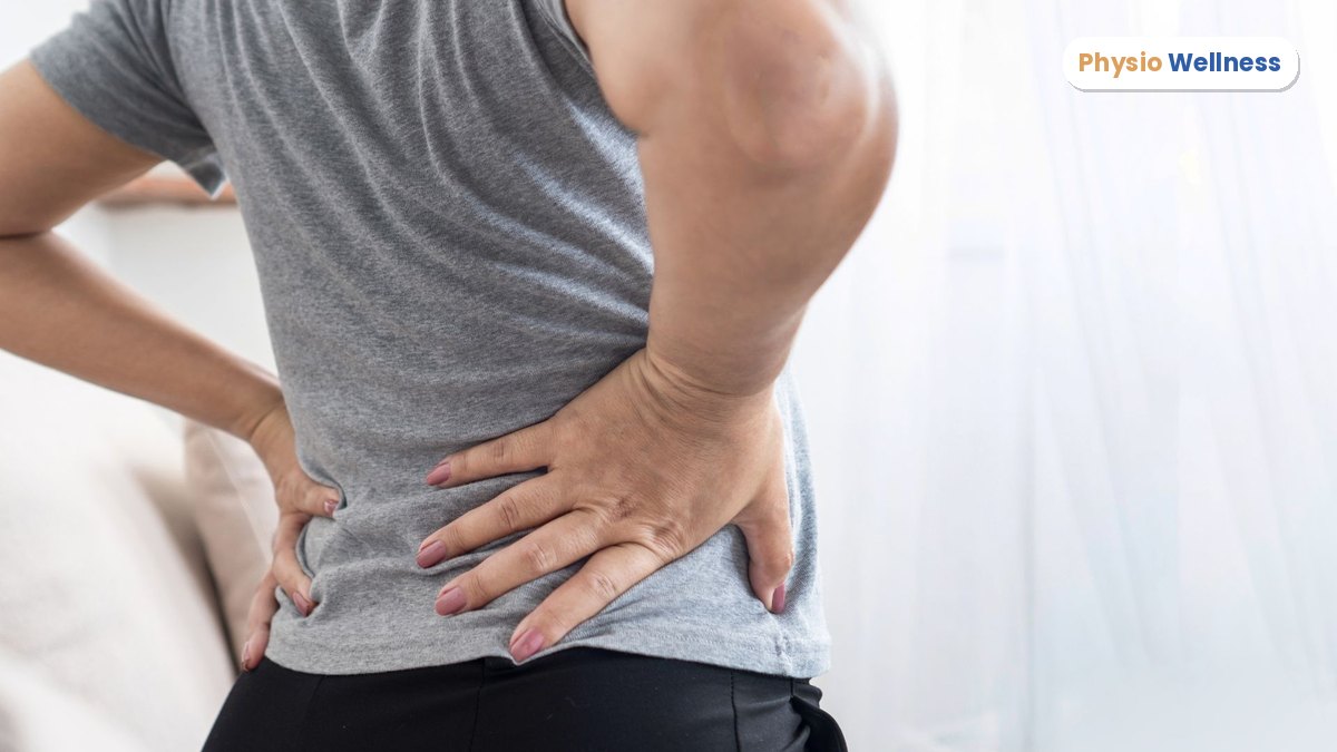 Person holding their lower back in pain from a herniated disc in Etobicoke